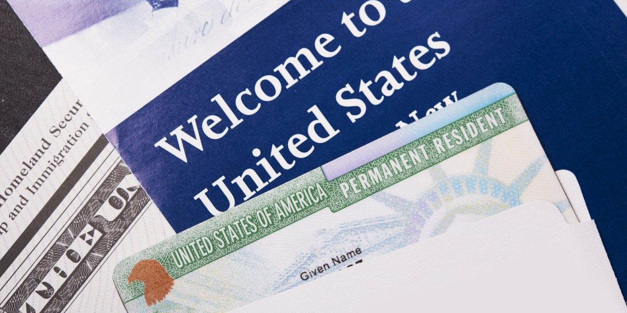 Welcome to the USA. Immigration Welcome Letter and Green Card Closeup. United States Homeland Security.